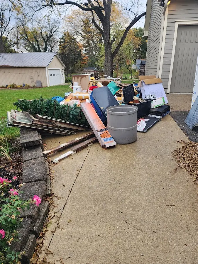 Dumpster being loaded with debris for Estate Cleanout Dumpster Rental in East Bethel